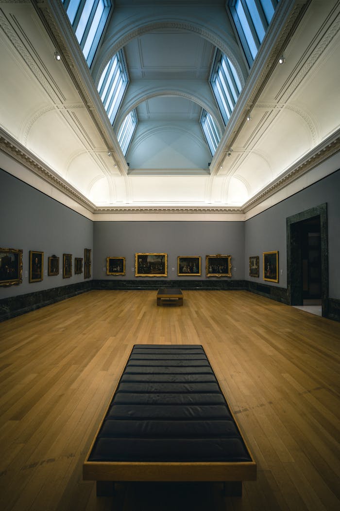 Explore this spacious and minimalist art gallery in London, featuring a modern wooden interior and vibrant paintings.