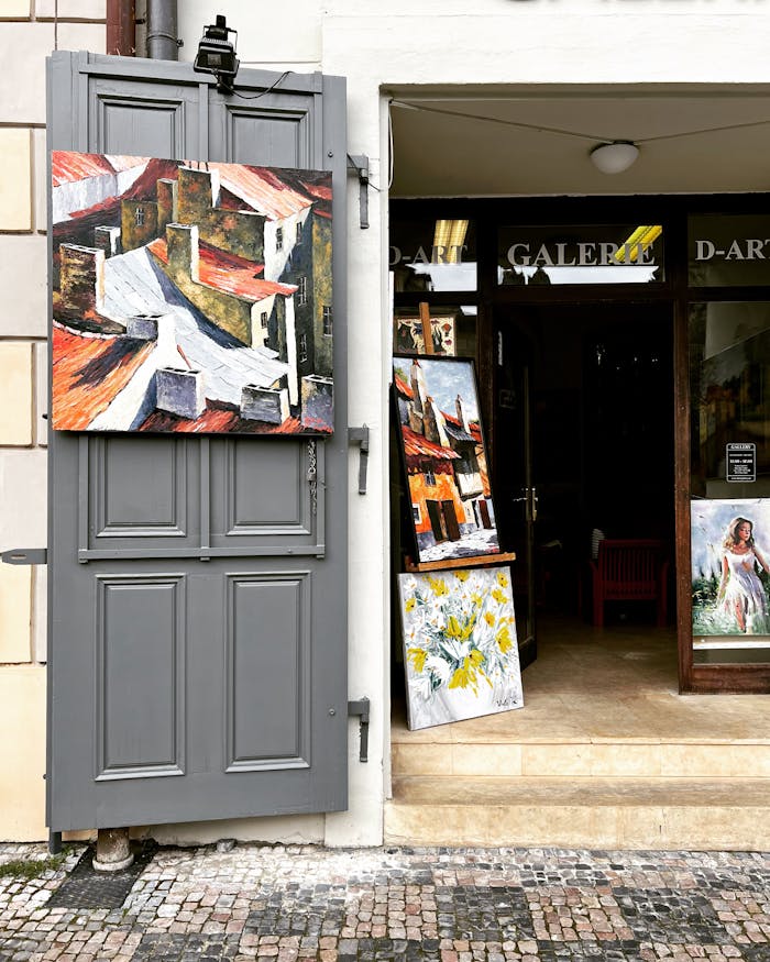 Art gallery exterior with paintings on display at the entrance, enhancing the creative ambiance.